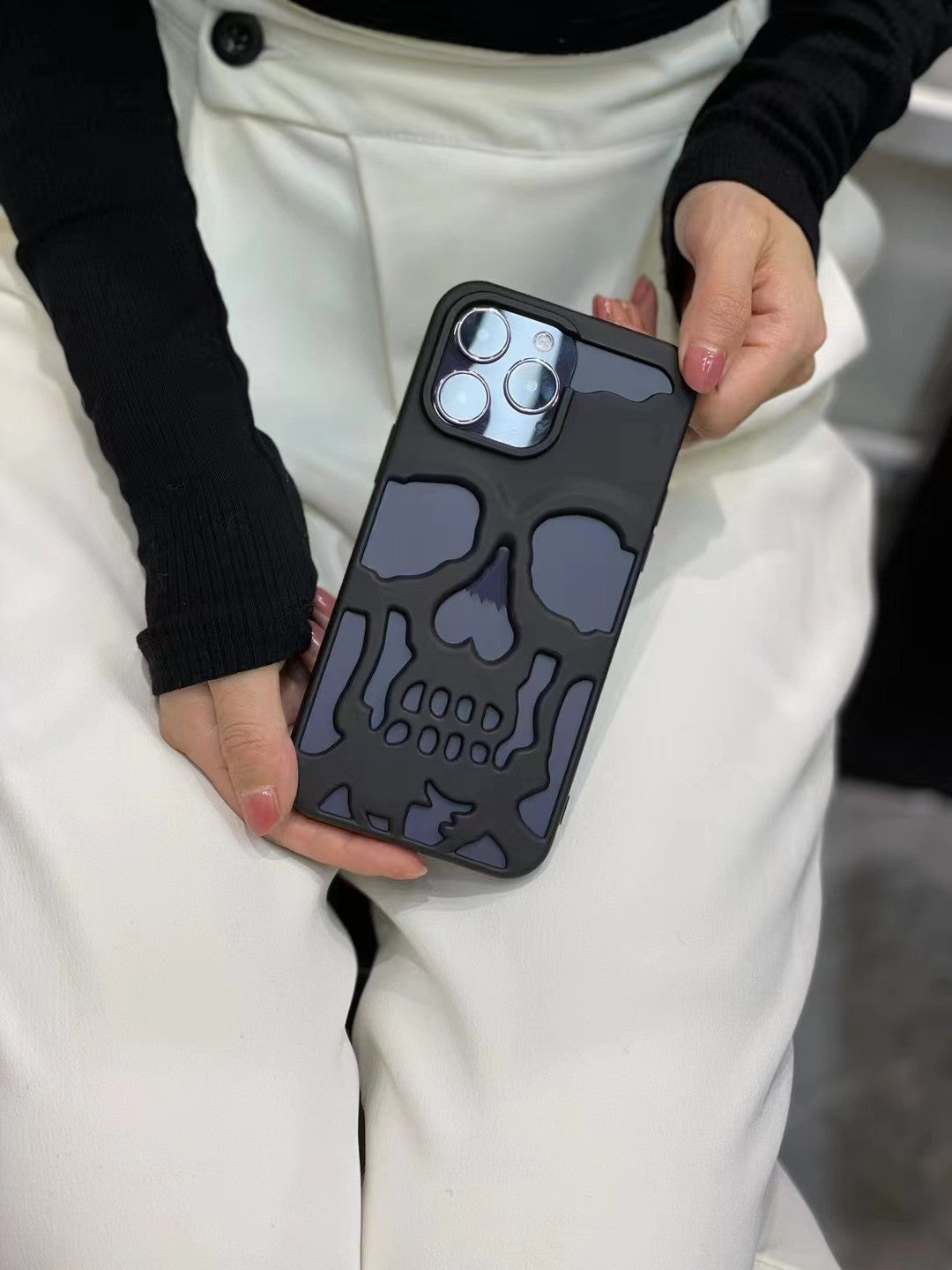 3D skull phone case held in hands, featuring a bold and artistic skull design for stylish protection
