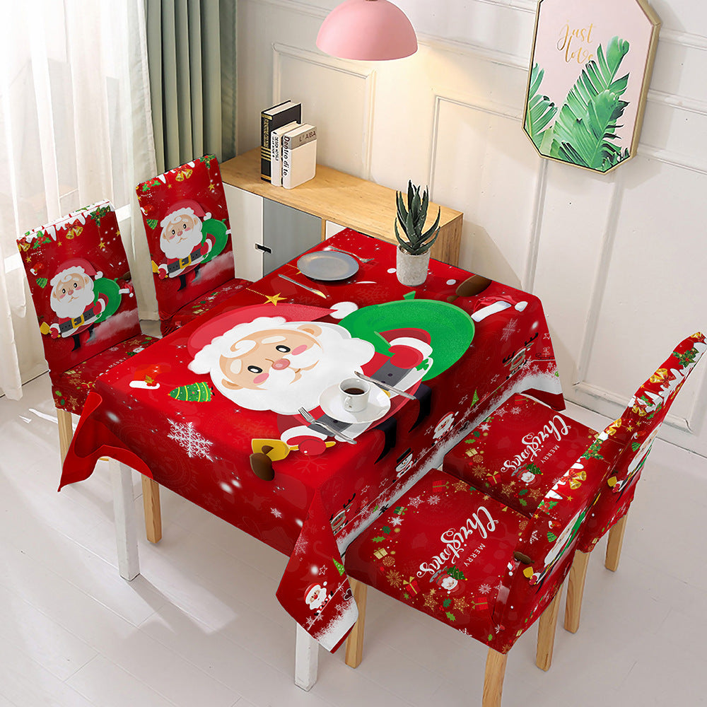 Christmas dining table decor featuring a festive red tablecloth with Santa and holiday designs for cheerful celebrations