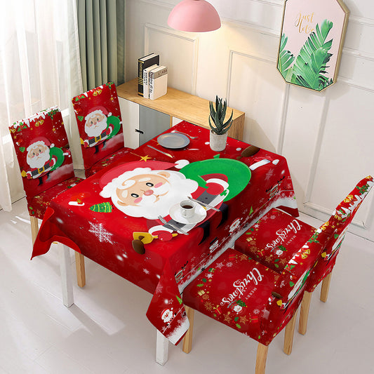 Christmas dining table decor featuring a festive red tablecloth with Santa and holiday designs for cheerful celebrations