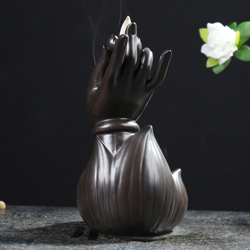 Creative incense burner shaped like a hand emerging from a lotus flower, perfect for indoor relaxation