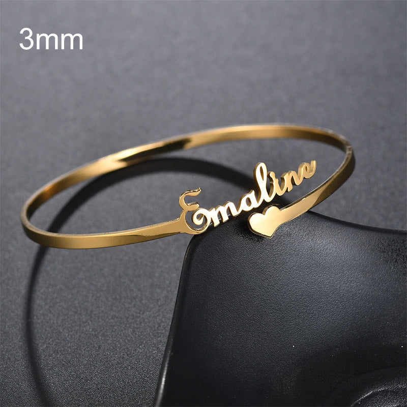 Gold Custom Name Bracelet with Heart Charm featuring the name Emaline in elegant script