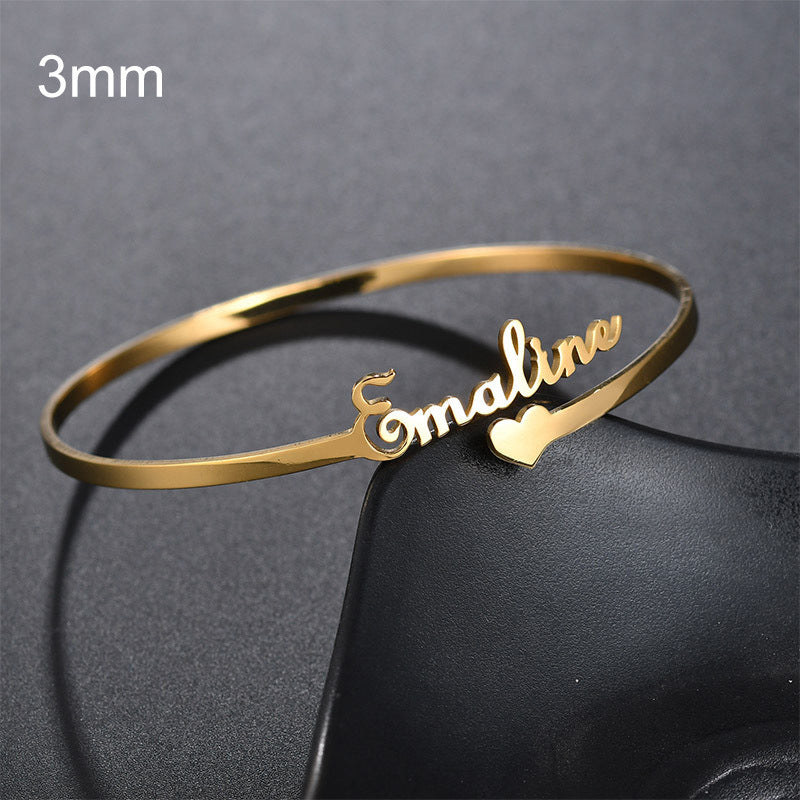 Gold custom name bracelet featuring the name Emaline with a heart symbol for personalized gift options