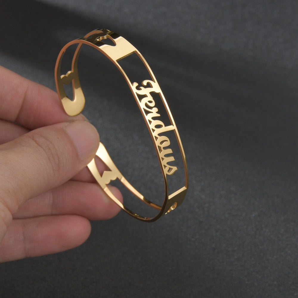 Gold custom name bracelet featuring the name Ferdaws with a sleek, modern design