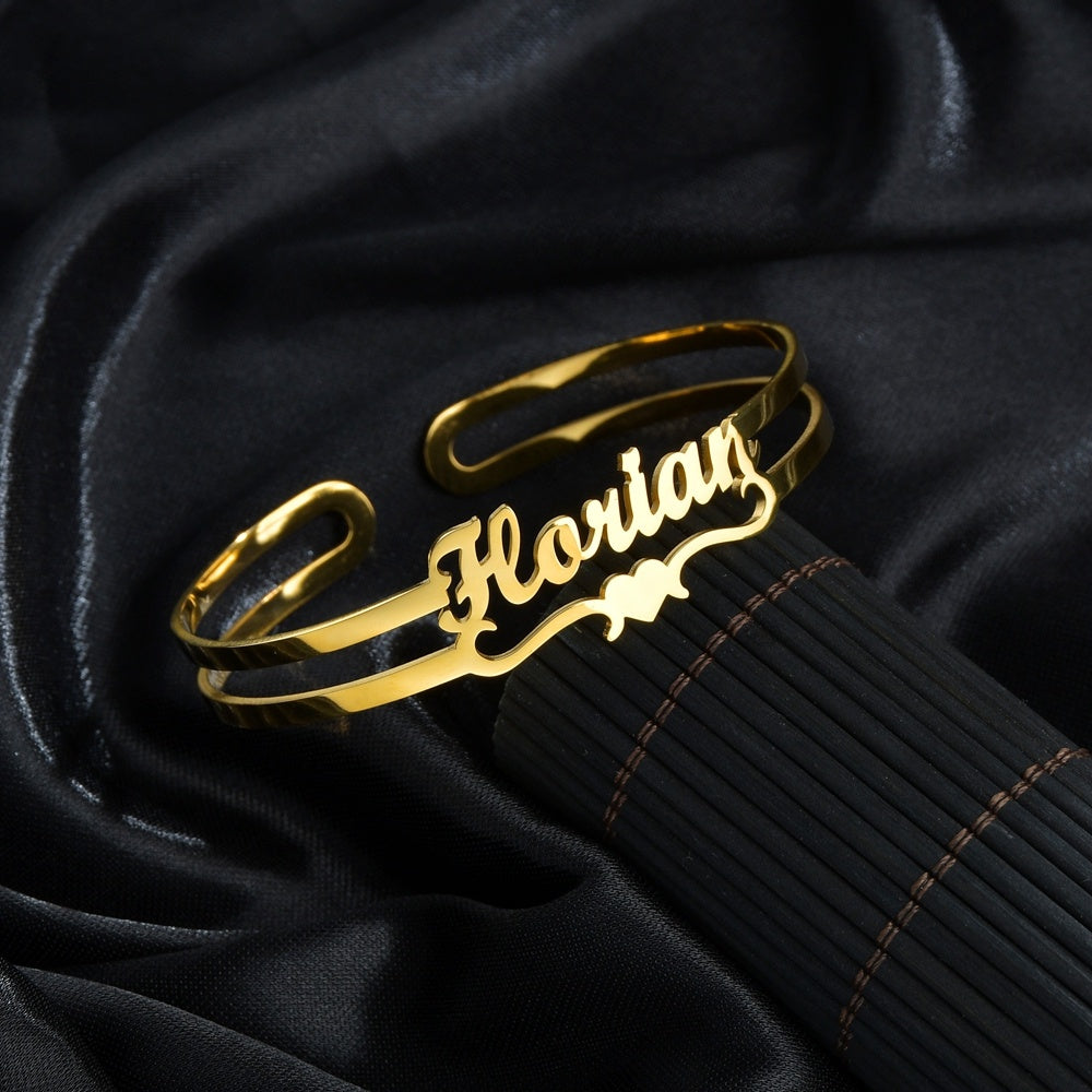 Custom name bracelet in gold featuring a stylish cursive design for personalized accessories