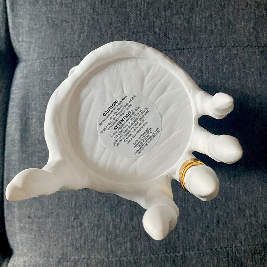 Halloween seat candlestick in white with a creative hand design for festive home decor