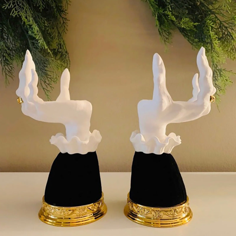 Unique Halloween seat candlestick featuring elegant white hands on a black base with gold detail