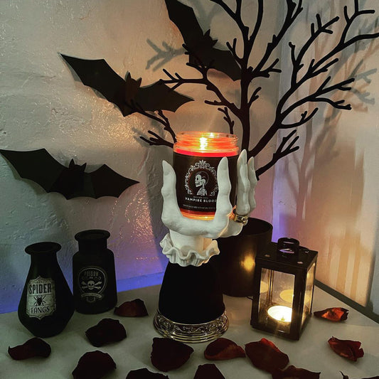 Halloween seat candlestick with spooky hand design and glowing candle for festive decor
