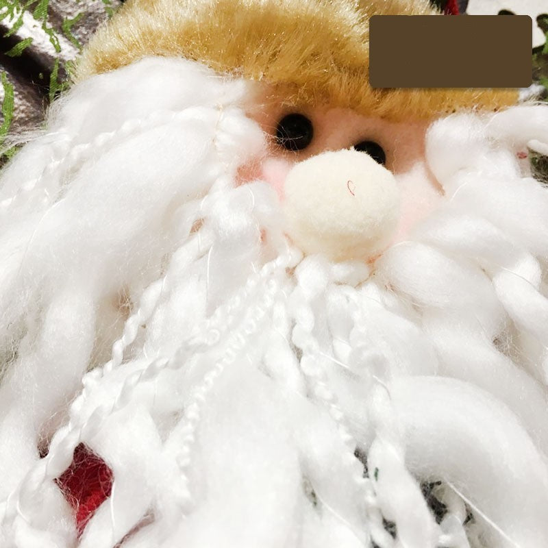Close-up of a festive Christmas Santa figurine with a fluffy white beard and golden hat