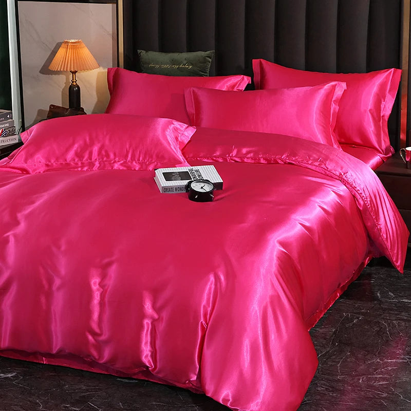 Luxury satin bedding set in vibrant pink color, featuring soft pillows and a smooth comforter