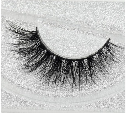 Long-lasting faux lashes on a sparkling background for dramatic eye looks