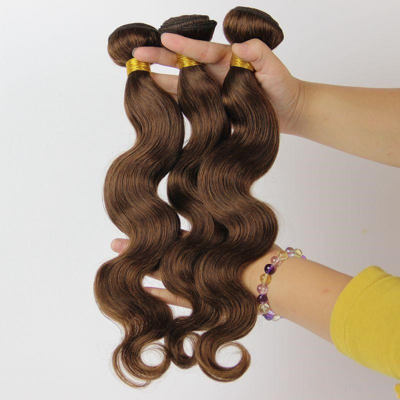 Soft and wavy real human hair extensions in brown shades held by a hand for styling versatility