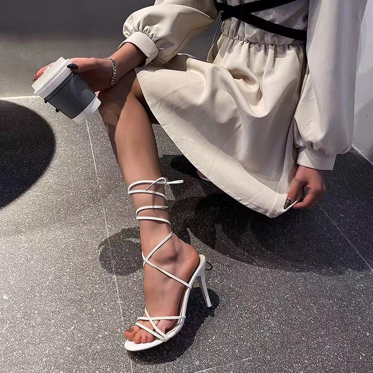 Stylish woman wearing a dress and round toe stiletto heels, perfect for seasonal fashion trends