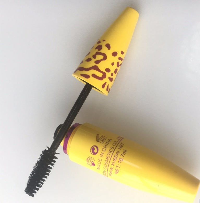 Volumizing waterproof mascara for thick lashes in a vibrant yellow tube with a unique design