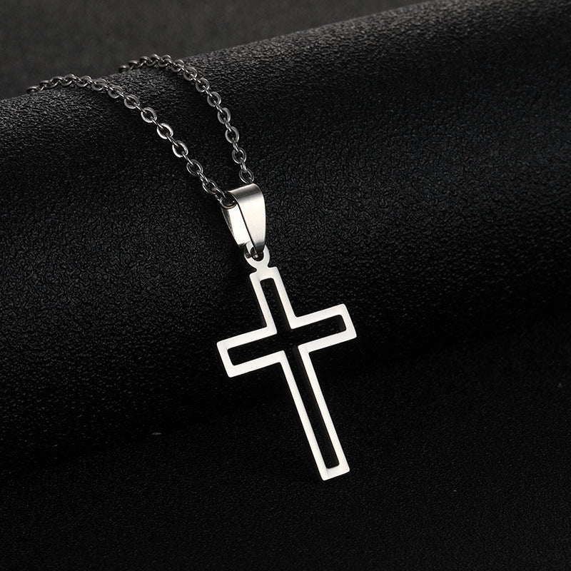 Stainless steel cross necklace on a black background, featuring a sleek design with a modern finish