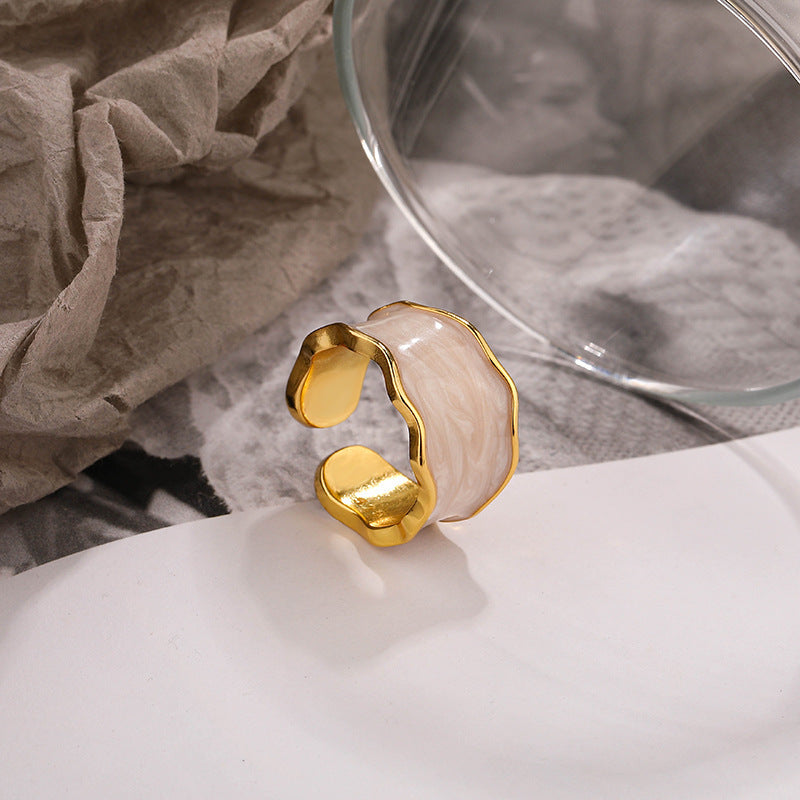 Stylish gold-accented accessory featuring a unique design with a sterling silver ring