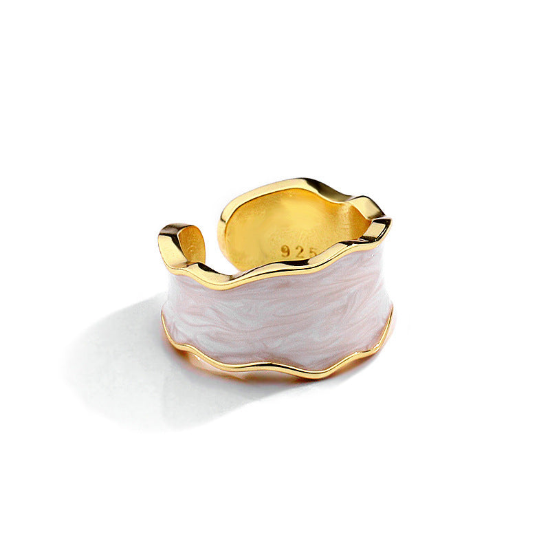 Unique sterling silver ring with a wavy design and gold accents, perfect for stylish accessories