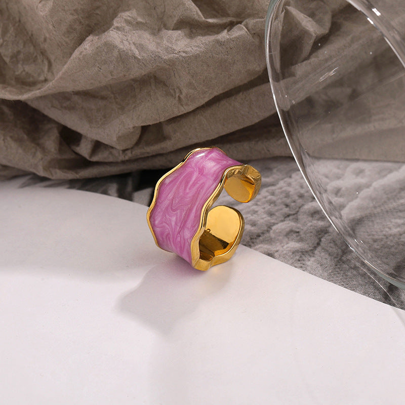 Colorful pink and gold adjustable ring featuring a unique wavy design, perfect for fashion accessories