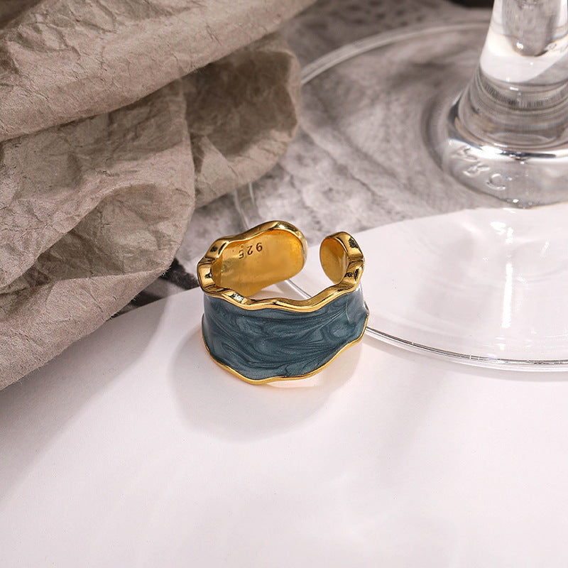 Stylish sterling silver ring with a unique wavy design and blue enamel finish